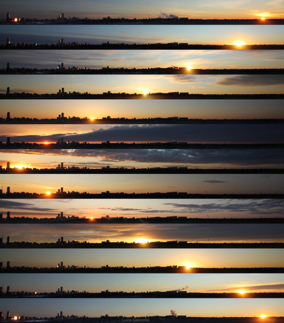 A composite time-lapse photograph of a sunrise or sunset over a city skyline, credited to Luca Vanzella. The image consists of thirteen horizontal panels stacked on top of each other, showing the progression of the sun across the horizon and the corresponding changes in the color of the sky, from dark blue to bright orange and yellow.