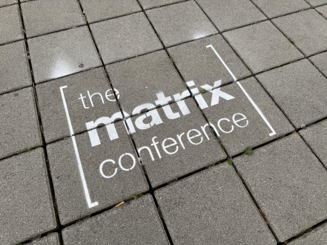 The logo of The Matrix Conference sprayed on the floor with chalk spray 