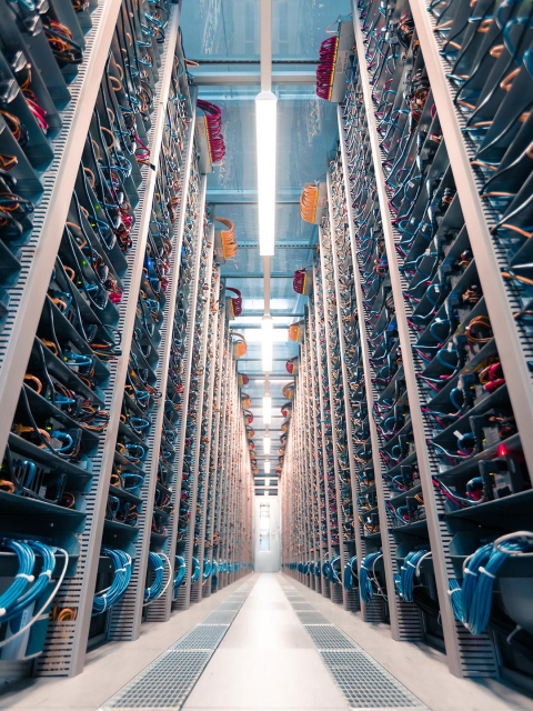 The image shows a cold aisle in the Hetzner data centre. 