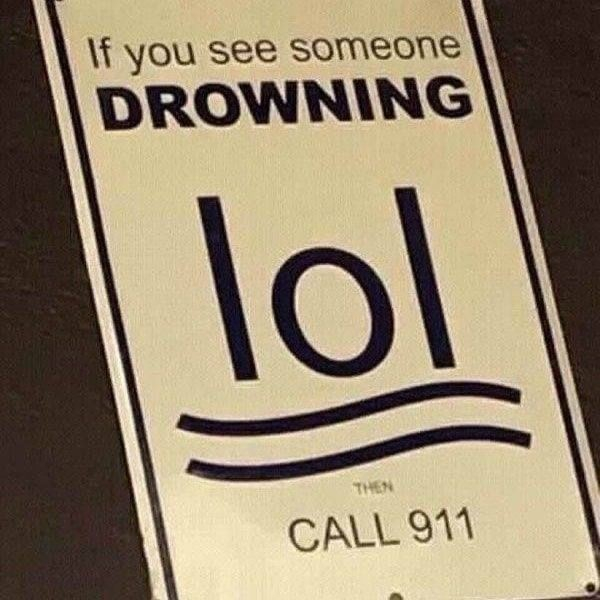 Sign that says "If you see someone drowning" underneath the graphic is supposed to be 2 arms and a head drowning in water, but instead it looks like "lol" and "call 911"