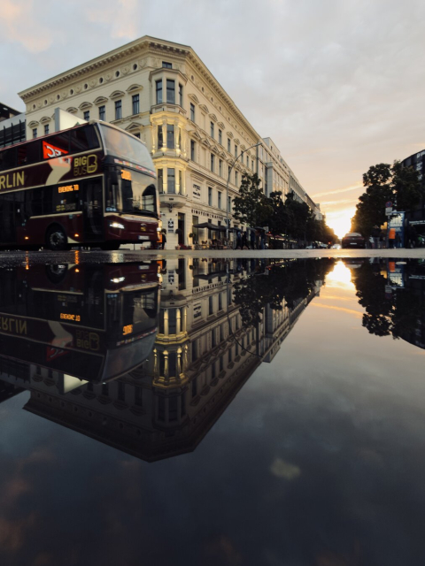 Bus driving into a crossing near Checkpoint Charlie in Berlin.