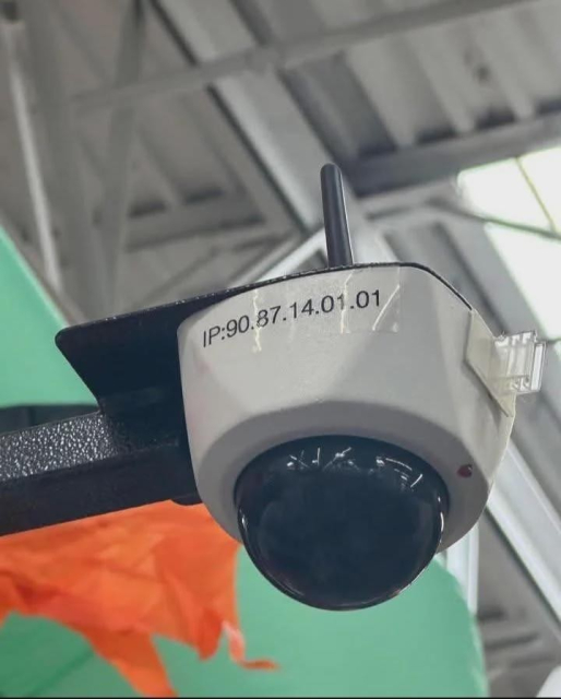 Photo of an in-store security camera with a label that says IP:90.87.14.01.01