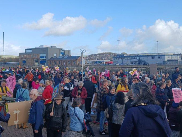 Large crowd gathered on the coast road in Newhaven to show solidarity with refugees and asylum seekers.