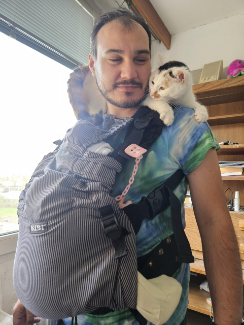 Štěpán with his daughter in a baby carrier on his chest and me on his shoulders receiving my advice