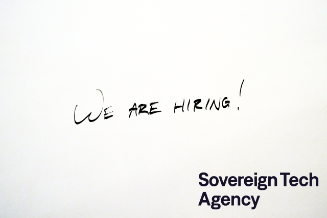 "We are hiring!" on a whiteboard, with the Sovereign Tech Agency logo in the bottom right corner.