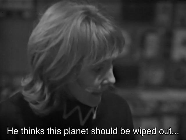 William Hartnell episode. Vicki is sitting at a table inside a small spaceship, talking to the Doctor, who’s just off screen. She’s from the future, and you can tell, because her sweater (?) has a weird zig-zag collar on it. Caption reads, “He thinks this planet should be wiped out…” Hm, I’d be willing to hear him out.