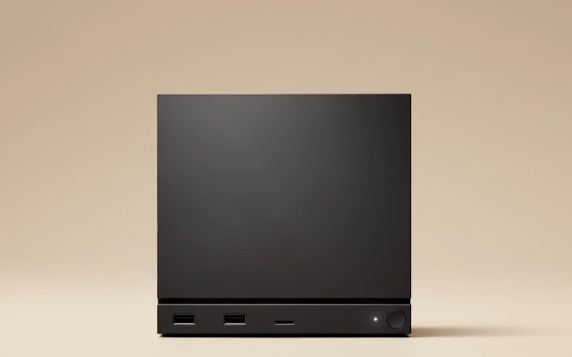 A simple black cube with a white LED in its bottom right hand corner on a beige background. That's it. Sorry it is not more exciting.