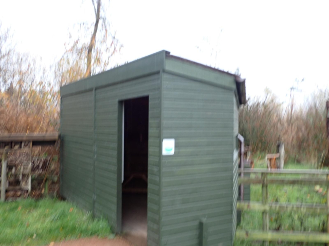 The bird hide overlooking the bird feeders at Morton Lochs. An insect 'hotel' to the left.