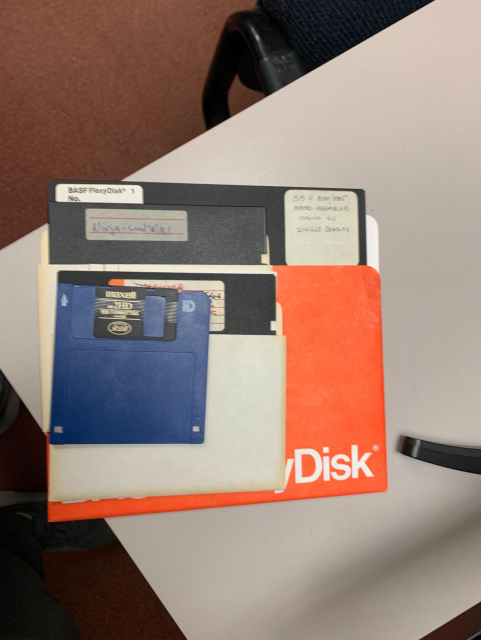 8 inch, 5.25 inch and 3.5 inch disks sitting on a grey table top.