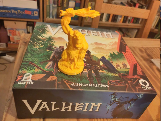 The Valheim board game with a 3D-printed troll figurine standing on top of it.