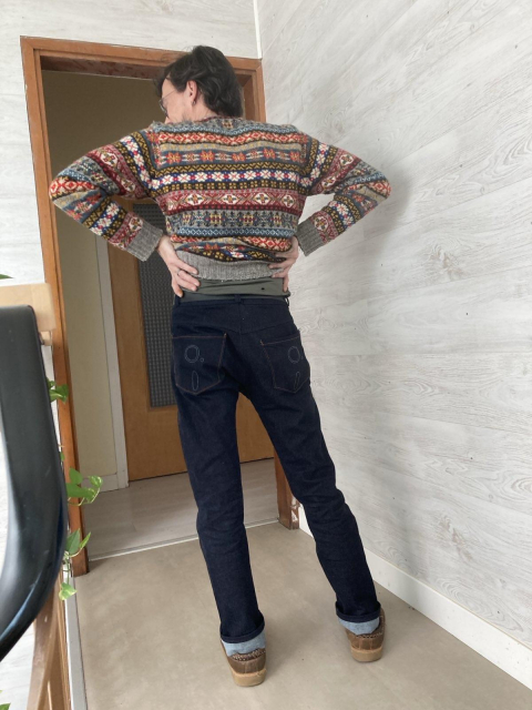 The jeans seen from behind, on me. The back pockets have 5.25" floppy designs on them!