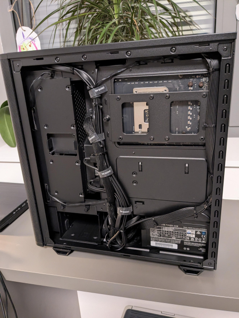 An opened PC case from the other side showing cable management.