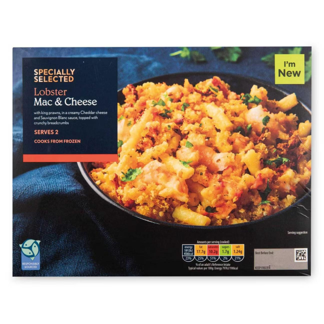 A box of “Specially Selected Lobster Mac & Cheese” featuring a close-up photo of a bowl filled with golden, breadcrumb-topped macaroni with visible seafood pieces. The dark blue packaging includes product details, nutrition info, and a green “I’m New” label.