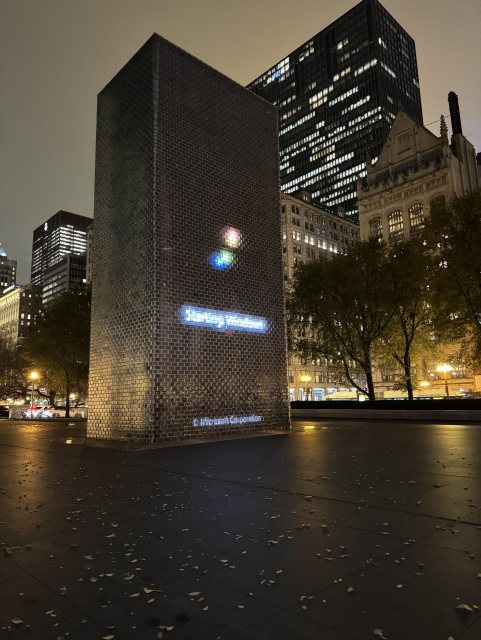 One of the pillars of the Crown Fountain displaying a Microsoft Windows boot animation instead of the usual parade of giant faces.

Photo taken the evening of 2025/11/20.