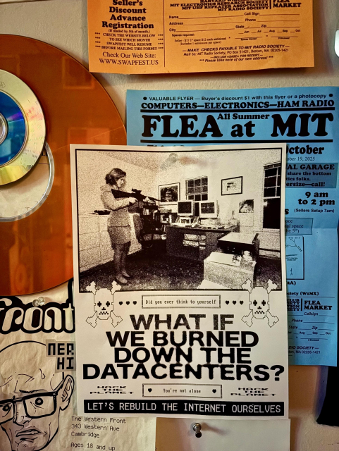 A flyer with a pixelated image of a woman aiming a gun in an office, asking "What if we burned down the datacenters? Let's rebuild the internet ourselves."