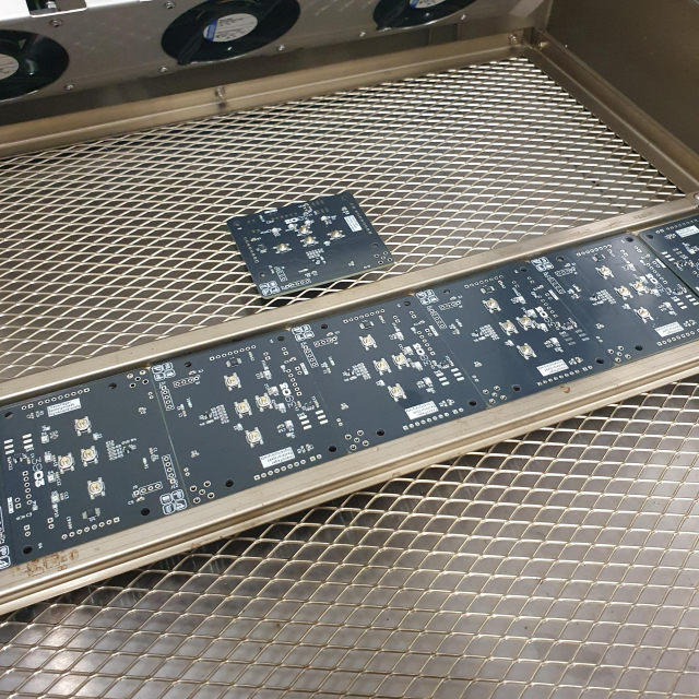 Dark PCB boards on a metal grid