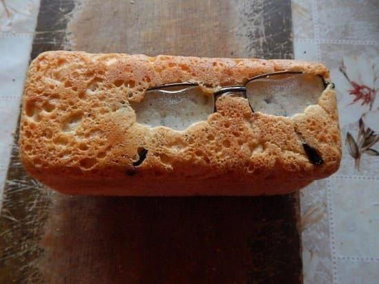 Photo of some glasses that have been baked into the bottom of a loaf of bread.