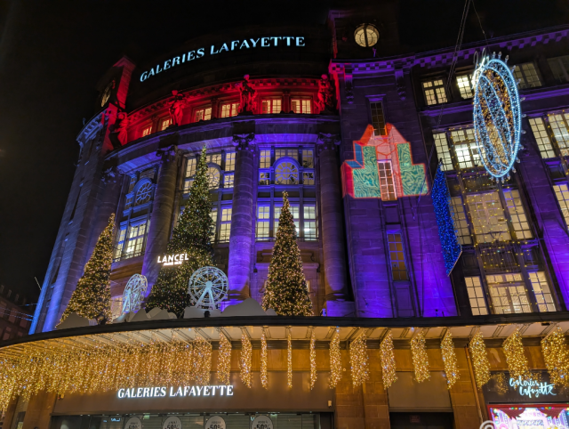 A building illuminated with multicoloured lights.
