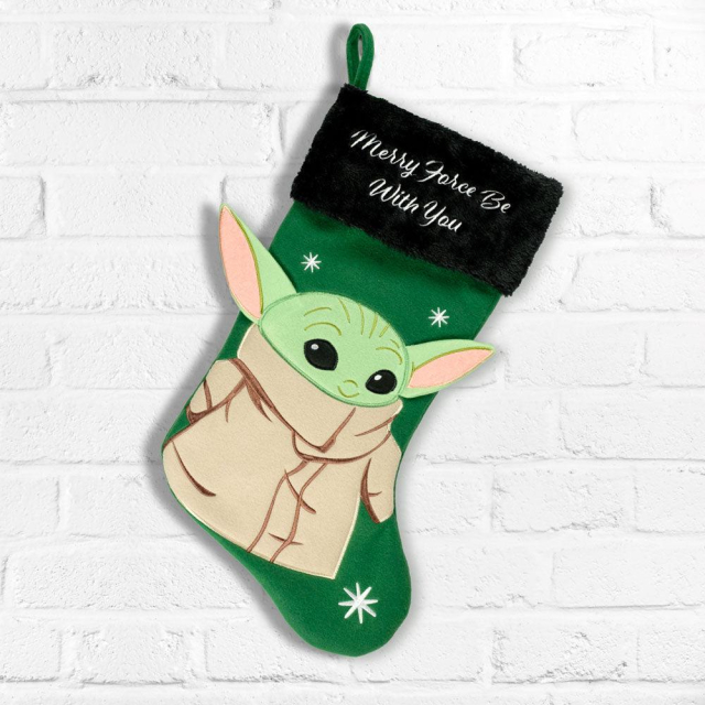 A green Baby Yoda Christmas Stocking. It says "Merry force be with you".