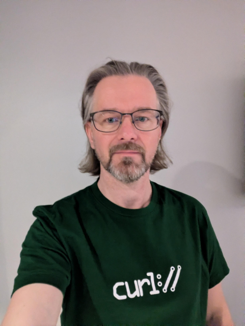 Jimmy wearing a green tshirt with the curl logo on it.