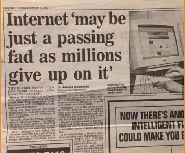 A photograph of a Daily Mail newspaper article from December 5, 2000, with the headline "Internet 'may be just a passing fad as millions give up on it'". The article includes a cropped photo showing hands typing on a keyboard in front of a computer displaying a website.