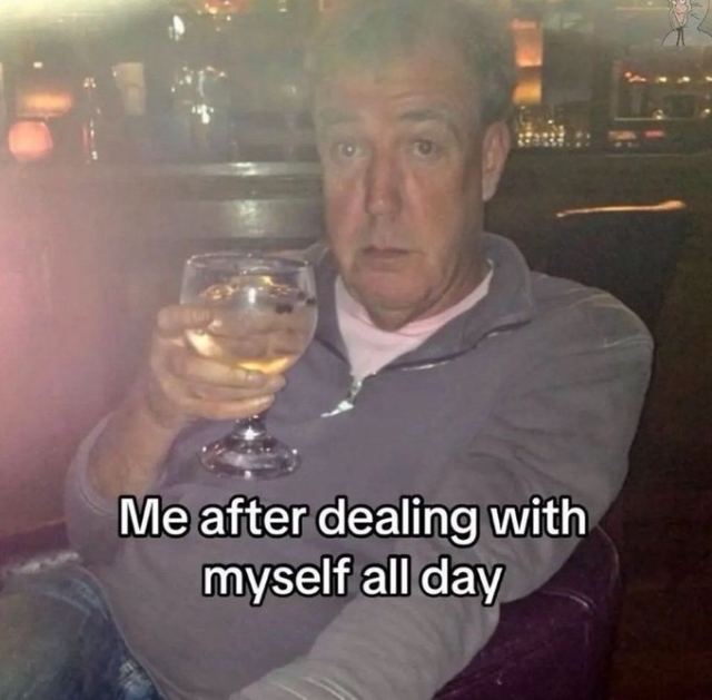 A meme featuring a photograph of Jeremy Clarkson sitting in a dimly lit bar, looking weary while holding a glass of clear drink with ice. The text overlaid on the image reads, "Me after dealing with myself all day"