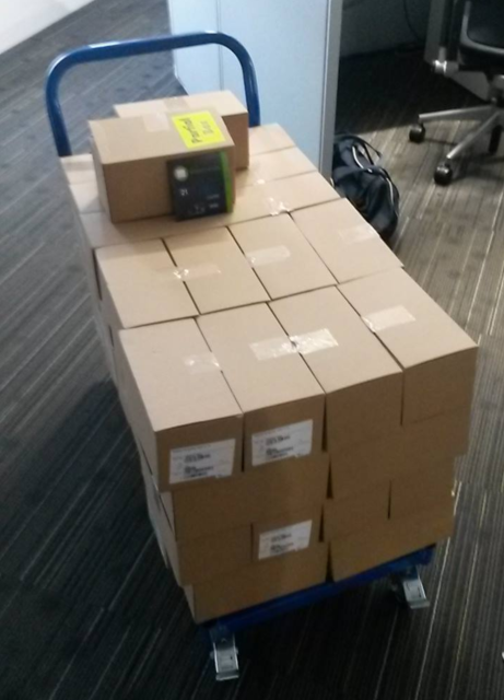 A cart piled high with paper boxes containing CDs.