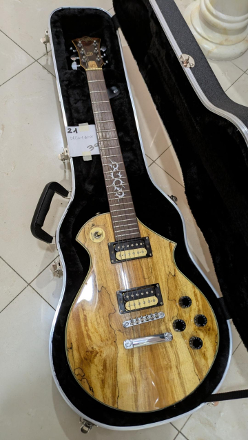 Picture of a natural wood finish Dreambow single cut guitar I bought