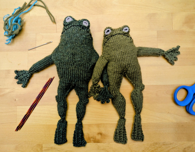 Knit Frog and Toad, holding hands.