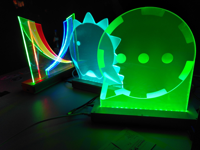 In the dark of the Hall H of the CDH in Hamburg, three wonderful illuminated logo of XMPP, Dino and Conversations are gently glowing.