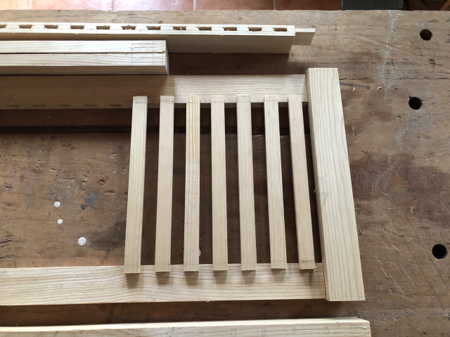 Las piezas de una de las puertas nada más sobrepuestas, para presentar cómo se van a ver. Es un marco más ancho que las tiras que componen la rejilla.