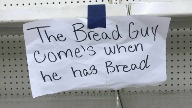 Sign on shelf reads “The Bread Guy come’s when he has bread.”