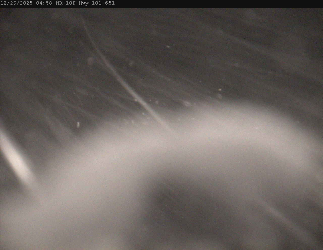 Highway 101 at 651 (Missanabie turnoff). A huge smear of snow across the camera, with rushing snow visible in the rest of the frame. Not even a hint that there might be a road out there somewhere.