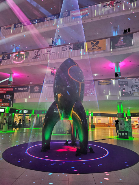 Picture of the congress rocket in various laser colors.  Taken from https://woof.tech/@Purple/115809359193169798