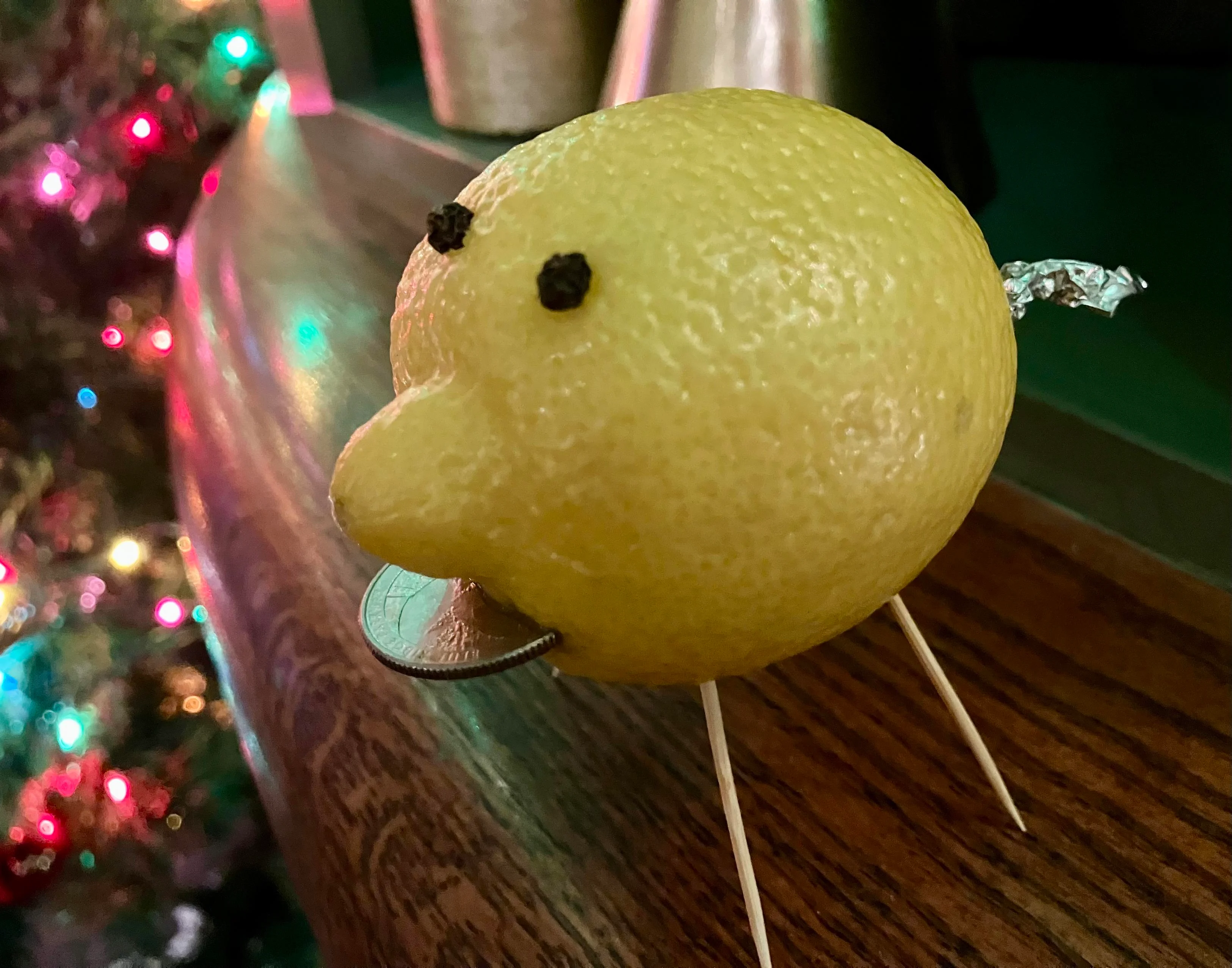 Lemon with toothpick legs, quarter mouth, foil tail, clove eyes and a big natural snout.
