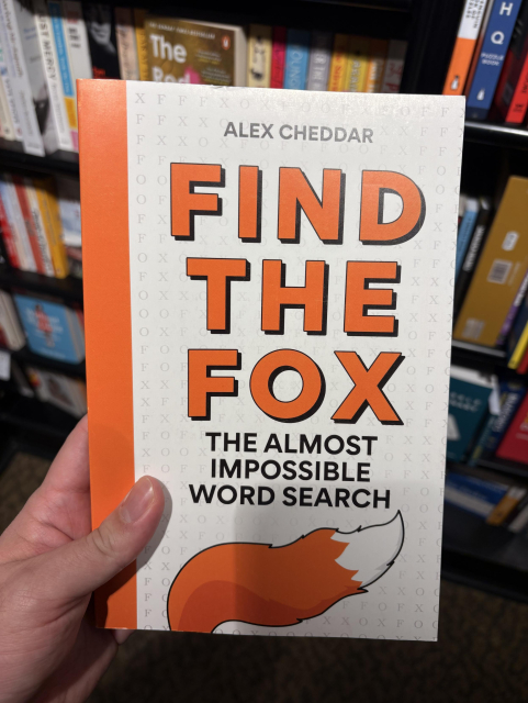 a book called “find the fox: the almost impossible word search” by alex cheddar, the bottom of the cover has a big fluffy fox tail