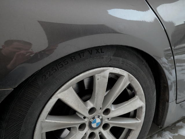 A close look at a rear wheel with the BMW logo.