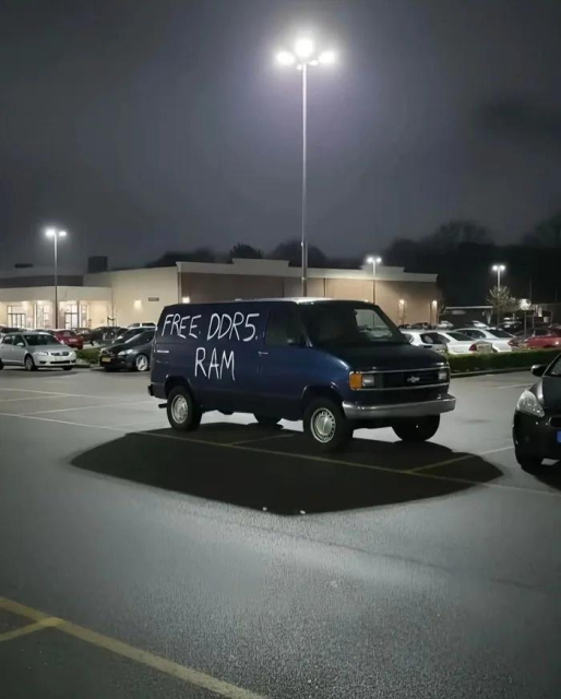 A parking lot at night with a sketchy looking van with “free DDR5 RAM” written on the side. 