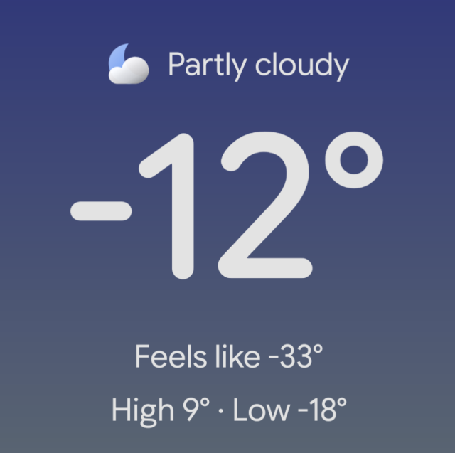 A weather forecast with the current temperature displayed as -12°F, which feels like -33°F. The sky is described as partly cloudy with a cloud icon.