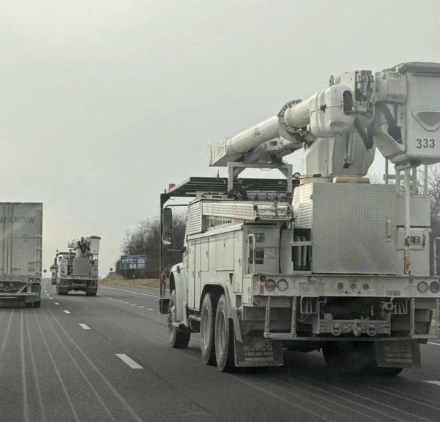 Linesmen trucks on an Ontario highway heading south.