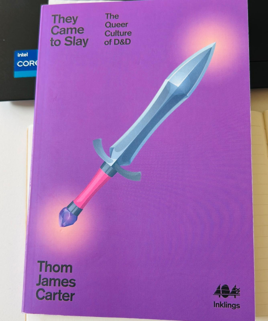 a purple book with a sword the cover 
title: They came to slay - the queer culture of DnD 
author: Thom James Carter