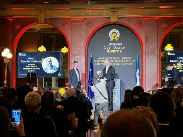 Two people on stage addressing the audience 