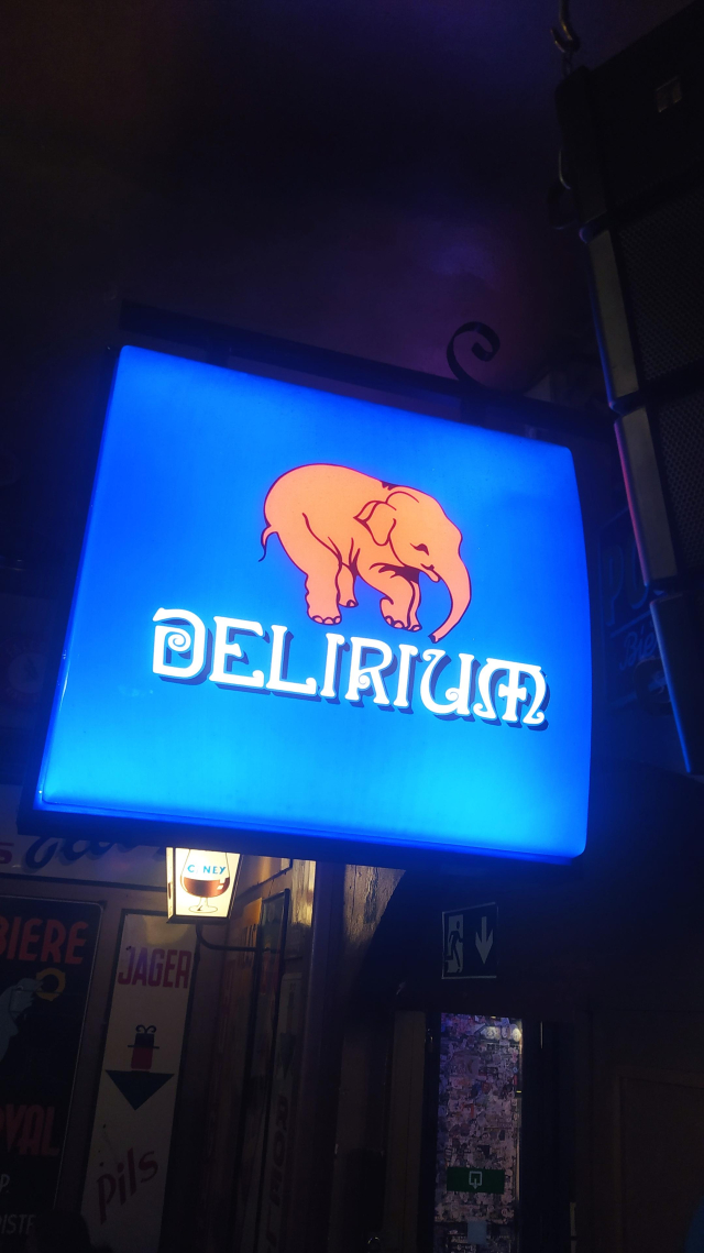 A large lit Delirium sign. 
