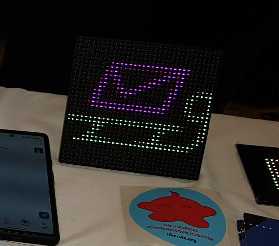 A version of the slidge logo on Ge0rg's 32x32 matrix LED display. A purple enveloppe on top of a yellow sledge.