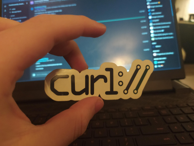 The face side of a curl sticker, it says curl://