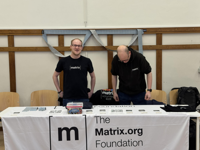 Two people having fun at the booth after one of them cracked a joke.