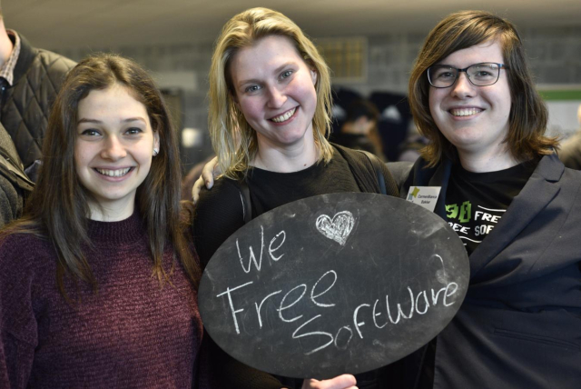 Three smiley people hold up a sign that says "We ❤️ Free Software" at FOSDEM 2019.

Photo credit: Redazione Cultura. distributed under CC By SA license. Find the original and more at https://www.dgpixel.com/techblog/i-love-free-software-day-2019/
