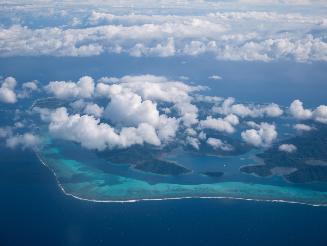 an atoll shrouded in clouds as seen from the sky