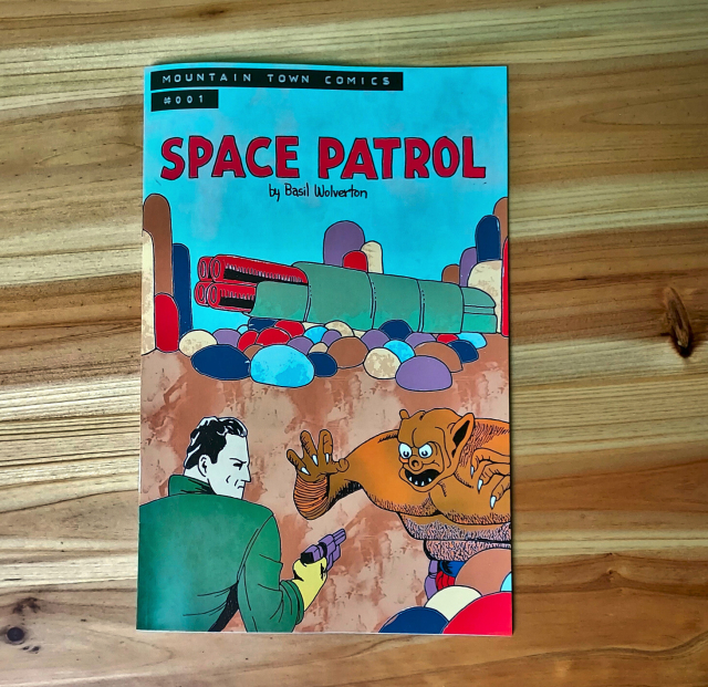a comic book I publish on a wooden table. 