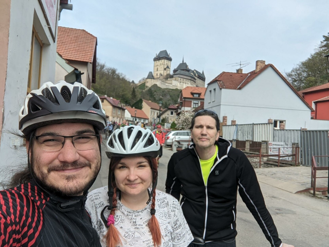 Selfie of me, Anna and uncle on bikes with Karlštejn in background